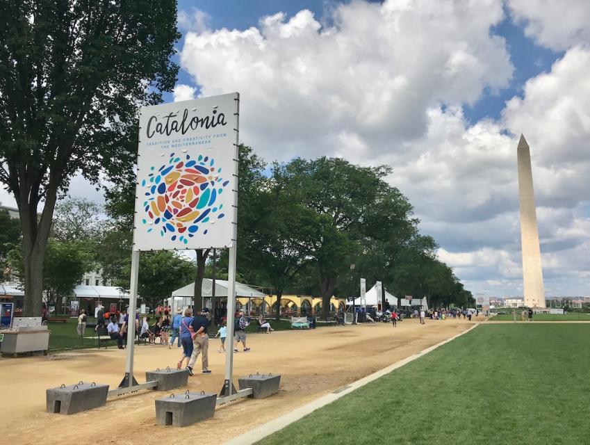 Stone pathway with large white sign to advertise Catalonia area of Folklife Festival