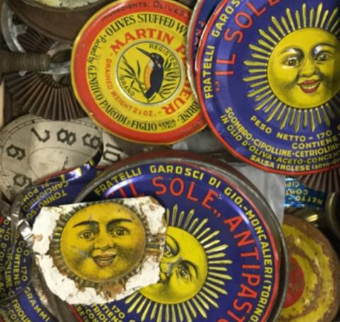 Box full of color tin can lids